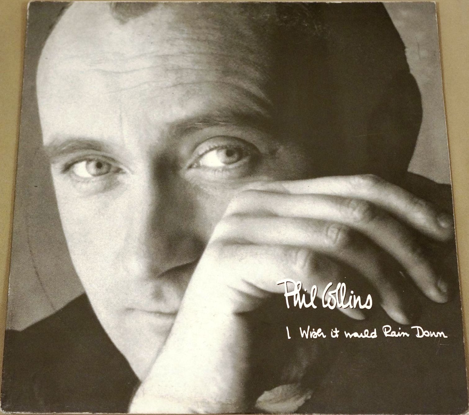 Phil Collins > I Wish It Would Rain Down